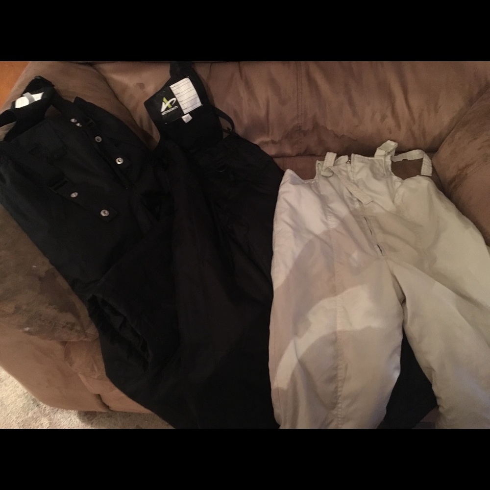 Two black snow suits and one off white one